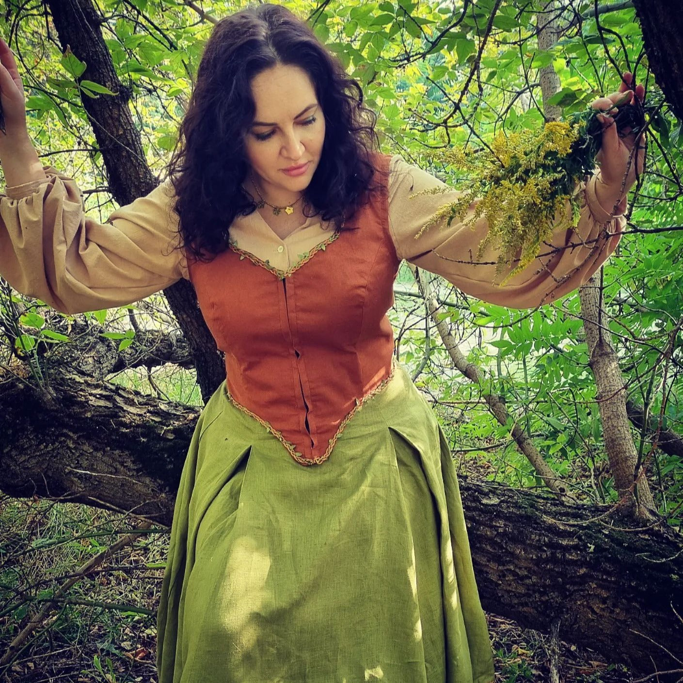 Rosie Cotton goblincore Shire costume. Handmade natural sustainability linen clothes: rust linen corset vest with leaves, olive twirl skirt and beige pirat blouse.